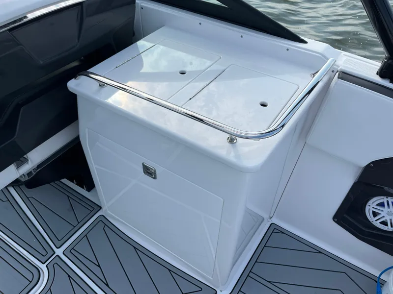 Slide: The Image of 2025 Monterey 255 Super Sport boat interior with sleek white storage compartment. - 21