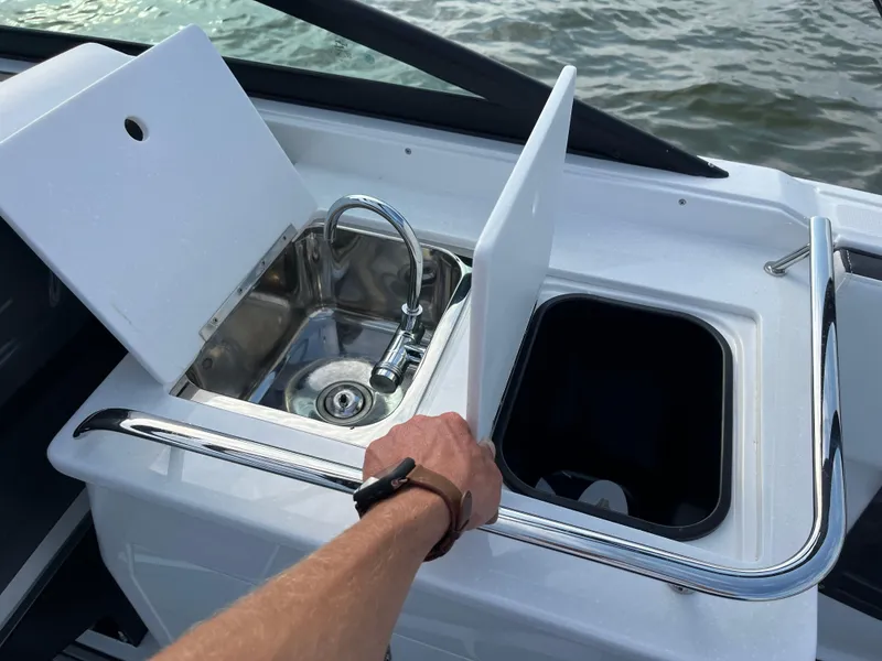 Slide: The Image of 2025 Monterey 255 Super Sport boat sink and storage area with water view. - 22