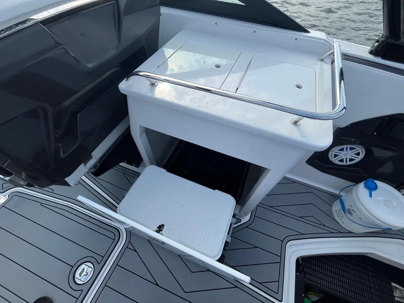 Slide: The Image of 2025 Monterey 255 Super Sport boat interior with storage compartment and sleek flooring. - 23