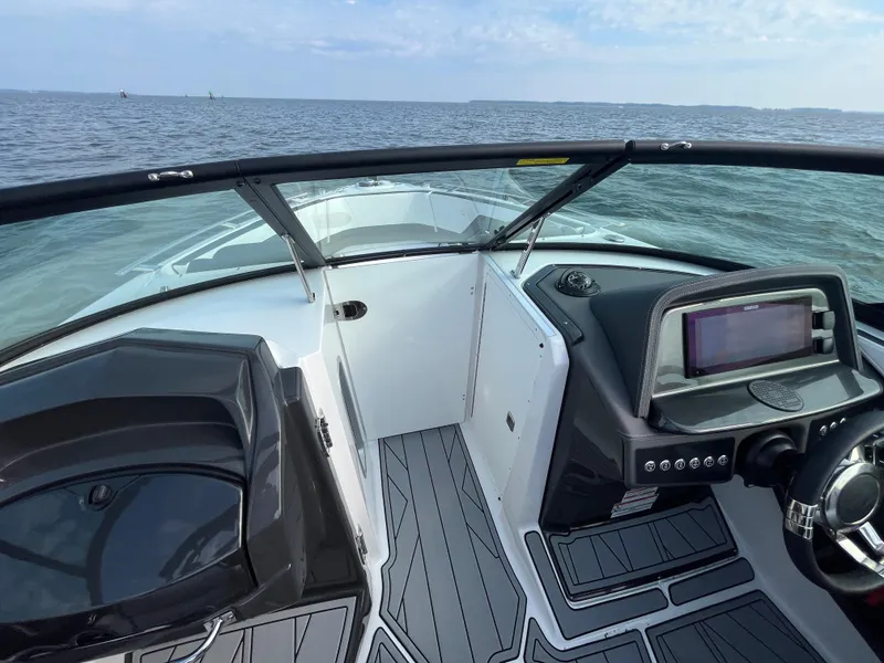 Slide: The Image of 2025 Monterey 255 Super Sport boat interior with sleek dashboard and open water view. - 36