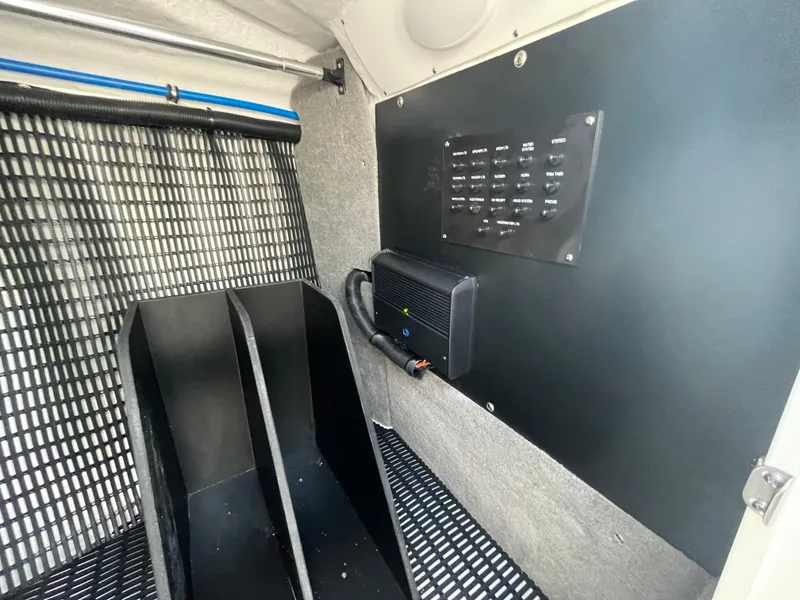 Slide: The Image of Interior of 2025 Monterey 255 Super Sport boat with control panel and storage compartments. - 40