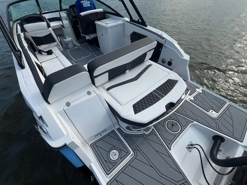 Slide: The Image of 2025 Monterey 255 Super Sport boat interior with sleek seating and modern design on water. - 9