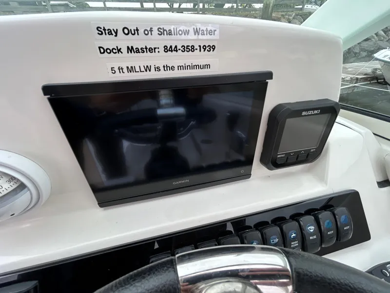 Slide: The Image of 2024 Sailfish 226 DC dashboard with navigation display and depth warning. - 10