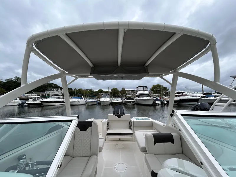 Slide: The Image of 2024 Sailfish 226 DC boat interior with canopy, docked at marina. - 15