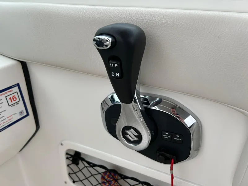 Slide: The Image of 2024 Sailfish 226 DC boat throttle control with Suzuki branding. - 18