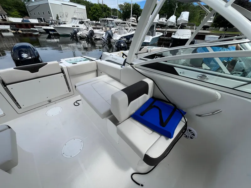 Slide: The Image of 2024 Sailfish 226 DC boat interior with seating and marina view. - 22