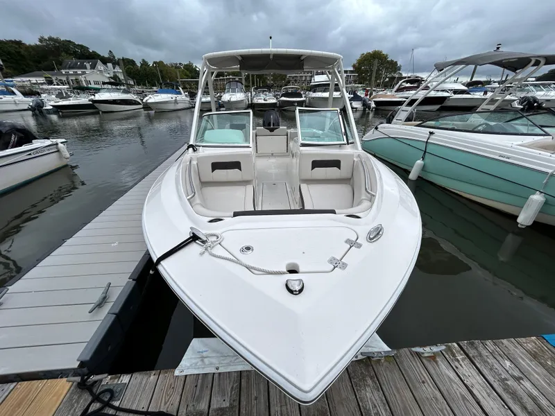 Slide: The Image of 2024 Sailfish 226 DC boat docked at marina under cloudy skies. - 5