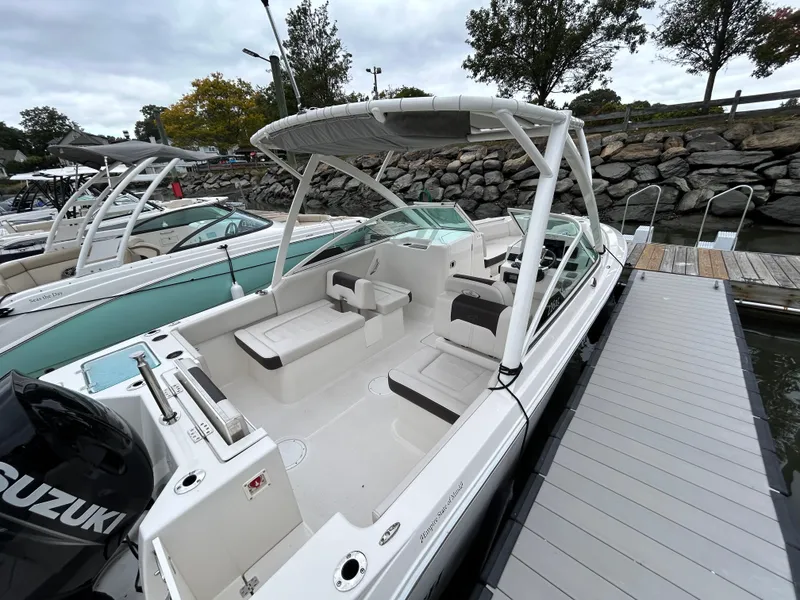 Slide: The Image of 2024 Sailfish 226 DC boat docked, featuring spacious seating and modern design. - 7