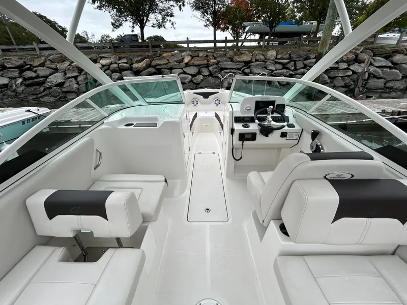 Slide: The Image of 2024 Sailfish 226 DC boat interior with white seating and modern dashboard. - 8