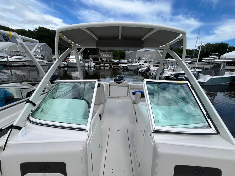 Slide: The Image of 2024 Sailfish 226 DC boat docked at marina, featuring open cockpit and dual consoles. - 11