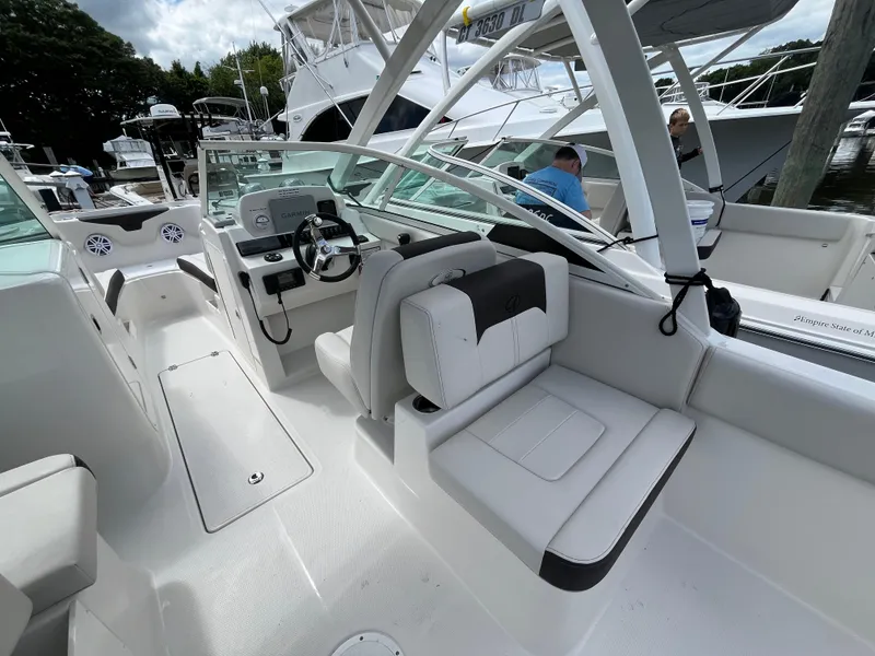 Slide: The Image of 2024 Sailfish 226 DC boat interior with modern seating and steering console. - 14