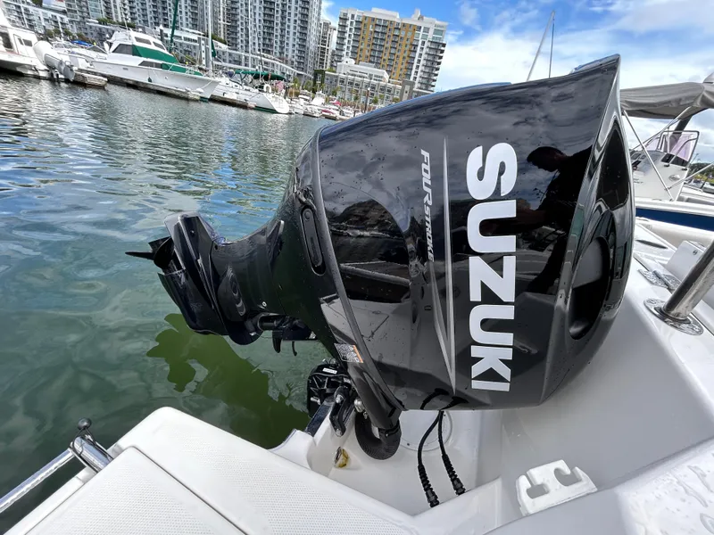 Slide: The Image of Suzuki outboard motor on 2024 Sailfish 226 DC boat in marina. - 17