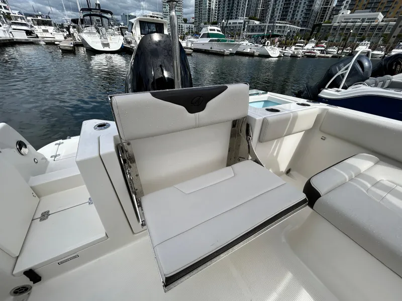 Slide: The Image of 2024 Sailfish 226 DC boat interior with seating, docked at marina. - 20