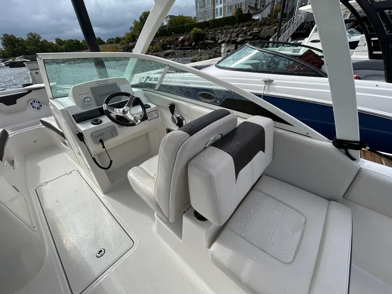 Slide: The Image of 2024 Sailfish 226 DC boat interior with steering wheel and seating. - 23