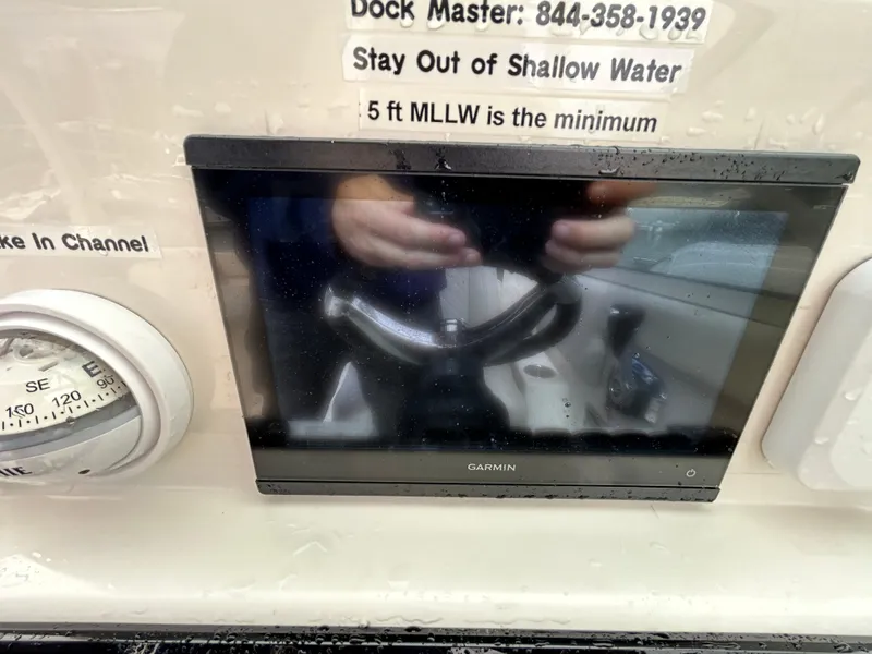 Slide: The Image of 2024 Sailfish 226 DC dashboard with Garmin display and navigation instruments. - 24