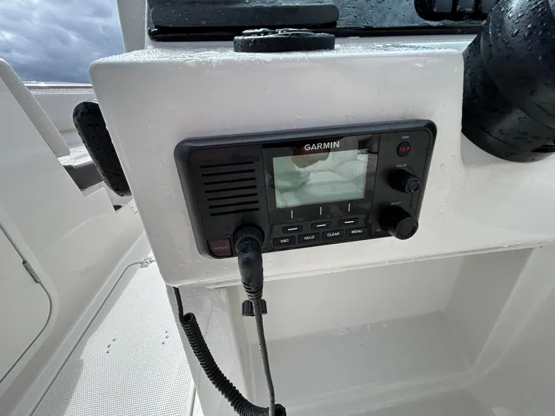 Slide: The Image of Garmin radio on 2024 Sailfish 226 DC boat dashboard. - 28