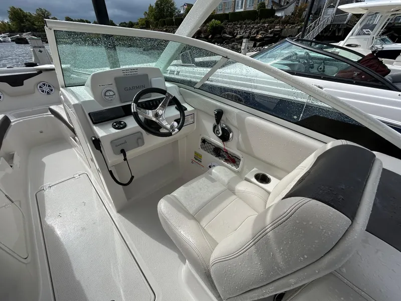 Slide: The Image of 2024 Sailfish 226 DC boat interior with steering wheel and seating. - 31