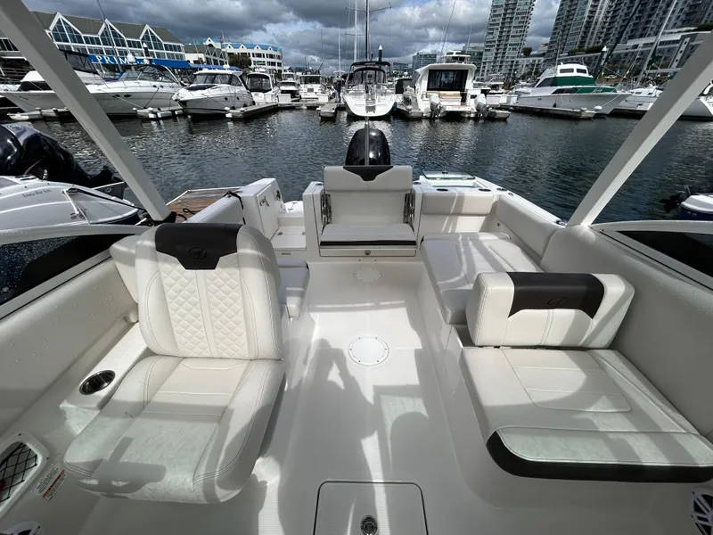 Slide: The Image of 2024 Sailfish 226 DC boat interior with white seating at marina. - 32