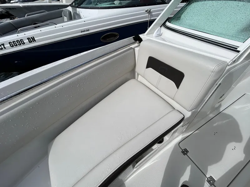 Slide: The Image of 2024 Sailfish 226 DC boat interior with white cushioned seating. - 6