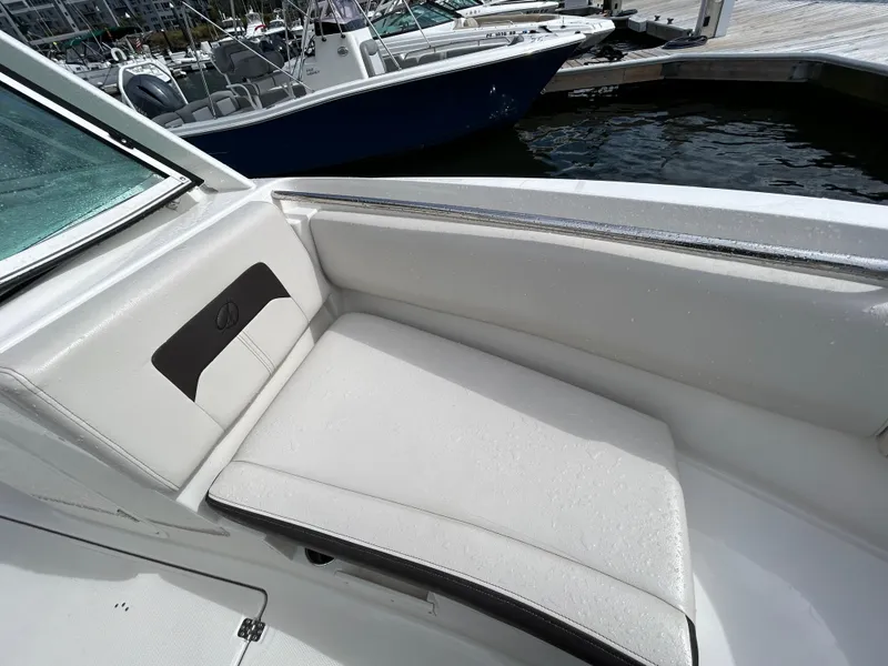 Slide: The Image of 2024 Sailfish 226 DC boat interior with white cushioned seating. - 7