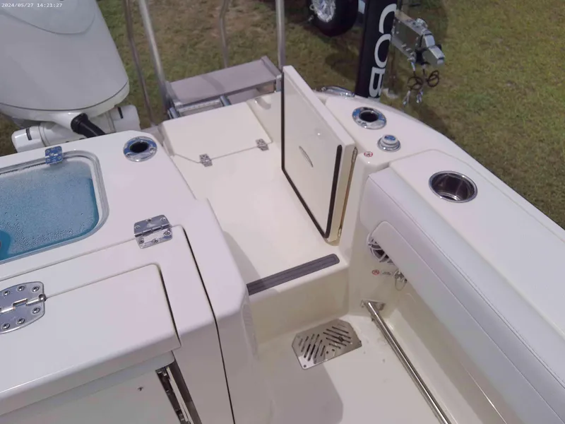 Slide: The Image of 2025 Cobia 265 Center Console boat interior, featuring storage compartments and fishing amenities. - 12