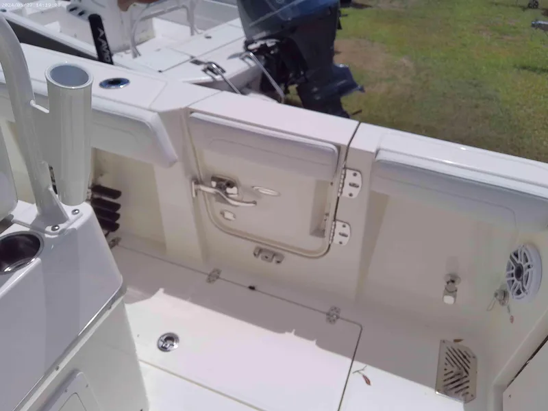 Slide: The Image of 2025 Cobia 265 Center Console boat interior with storage compartments and fishing rod holders. - 6