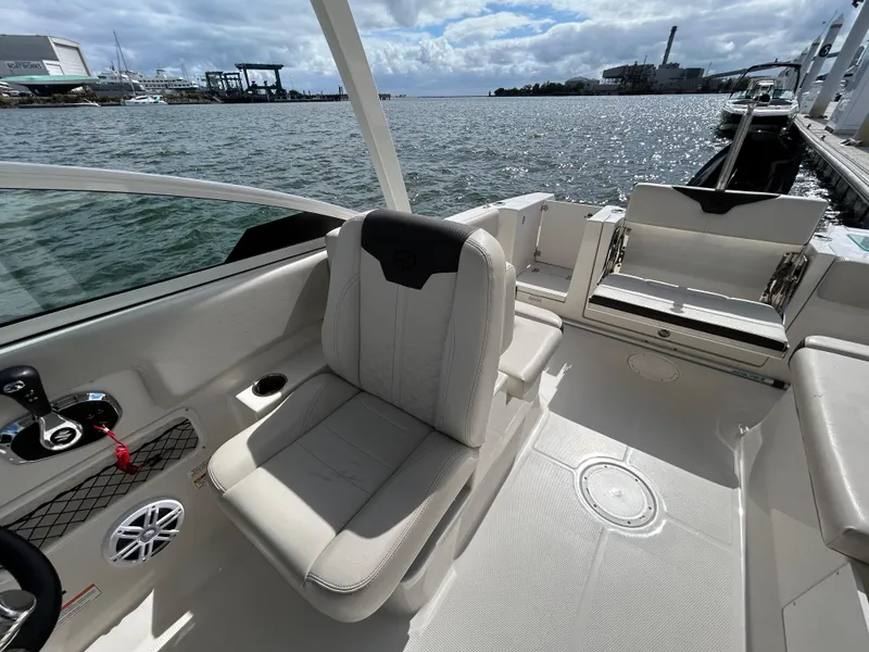 Slide: The Image of 2024 Sailfish 226 DC boat interior with comfortable seating and waterfront view. - 11