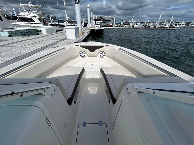 Slide: The Image of 2024 Sailfish 226 DC boat interior at marina, featuring spacious seating and modern design. - 14