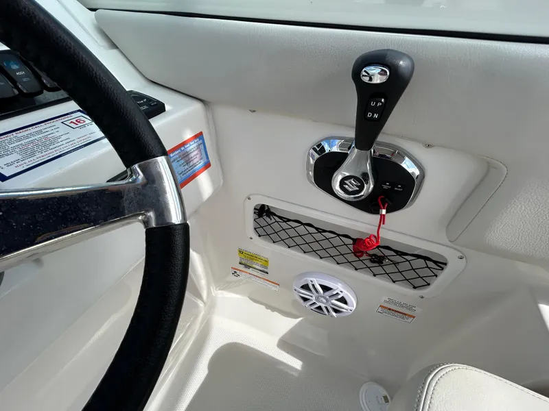 Slide: The Image of 2024 Sailfish 226 DC boat interior, steering wheel, throttle control, and speaker detail. - 5