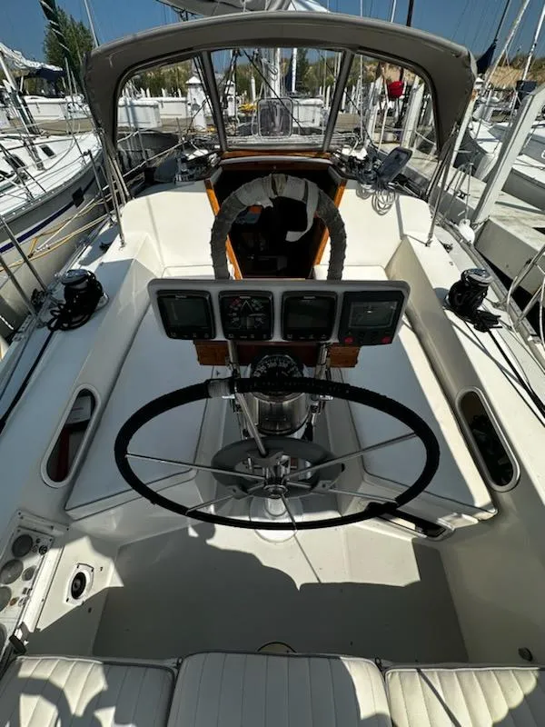 Slide: The Image of Cockpit of a 1994 Catalina 36 sailboat with steering wheel and navigation instruments. - 12