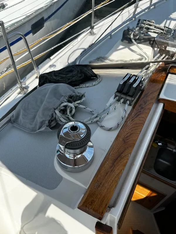 Slide: The Image of 1994 Catalina 36 sailboat deck with winch, ropes, and wooden trim. - 15