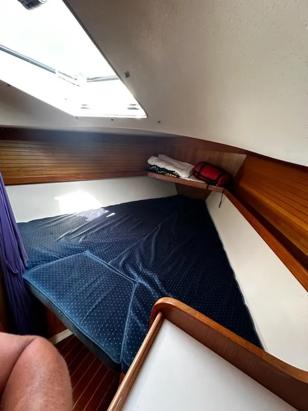 Slide: The Image of Cozy cabin interior of a 1994 Catalina 36 sailboat with a skylight and wooden accents. - 18