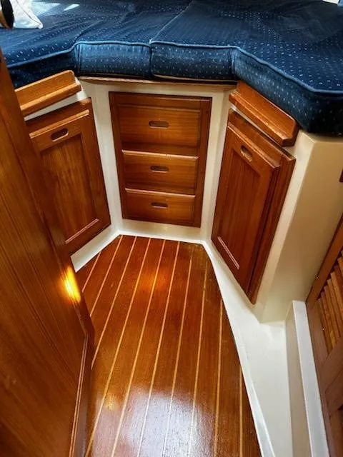 Slide: The Image of Interior of 1994 Catalina 36 sailboat with wooden cabinets and blue cushioned seating. - 19