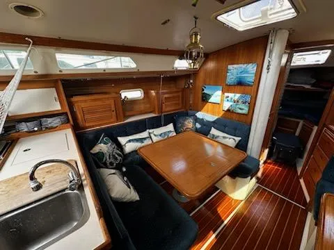 Slide: The Image of Interior of a 1994 Catalina 36 sailboat with cozy seating and wooden finishes. - 24