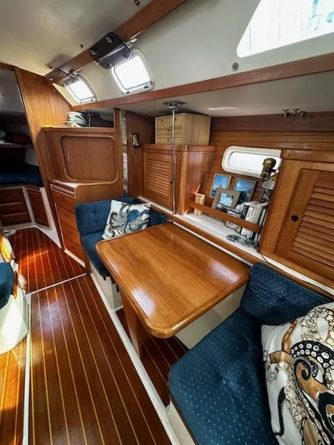 Slide: The Image of Interior of 1994 Catalina 36 sailboat with wooden finishes and blue seating. - 25