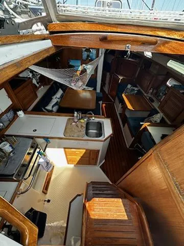 Slide: The Image of Interior of 1994 Catalina 36 sailboat with kitchen, seating, and wooden finishes. - 26
