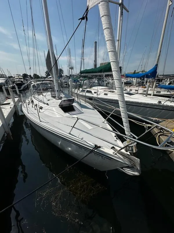 Slide: The Image of 1994 Catalina 36 sailboat docked at marina, surrounded by other boats. - 5