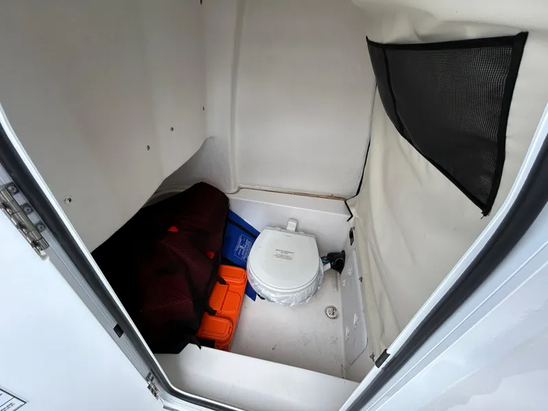 Slide: The Image of Interior storage compartment of 2025 Sea Fox 248 Commander boat with portable toilet. - 14