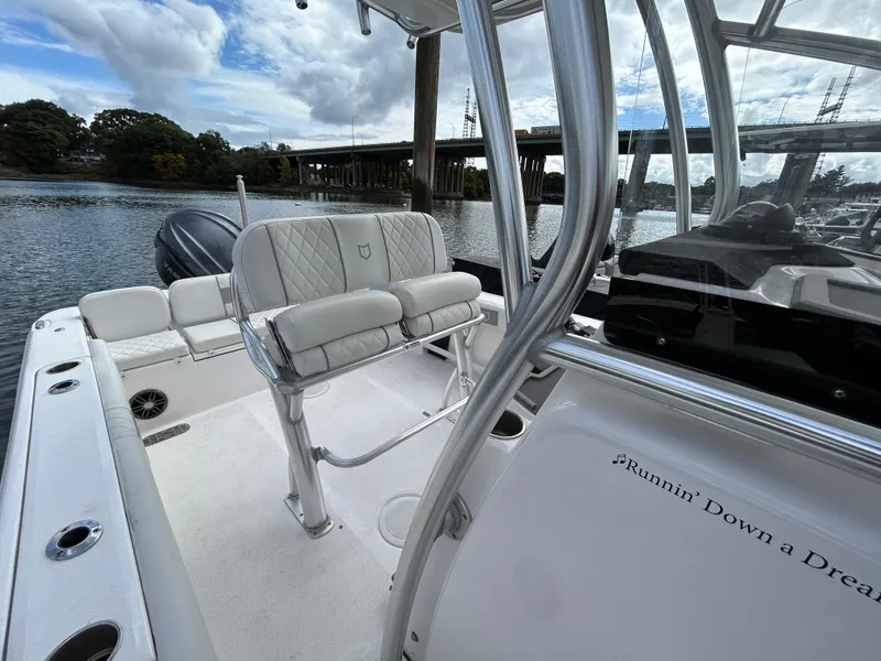 Slide: The Image of 2025 Sea Fox 248 Commander boat interior with seating, on a calm river. - 17