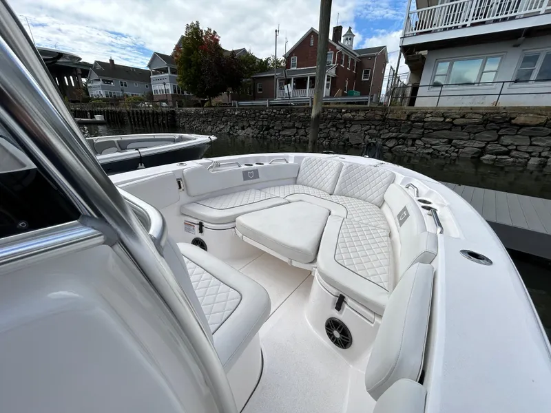 Slide: The Image of 2025 Sea Fox 248 Commander boat with luxurious seating in a marina setting. - 18