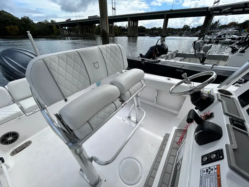 Slide: The Image of 2025 Sea Fox 248 Commander boat interior with white seating and steering console. - 19