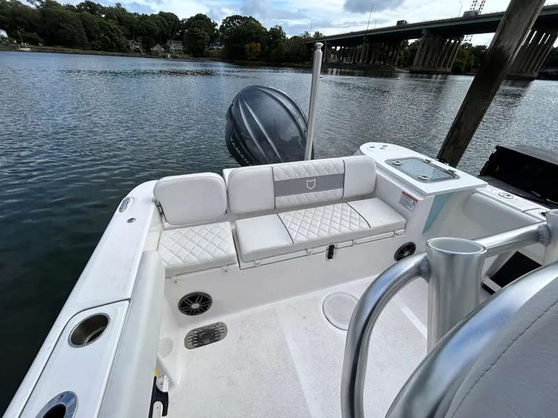Slide: The Image of 2025 Sea Fox 248 Commander boat interior with seating, on a calm river. - 25