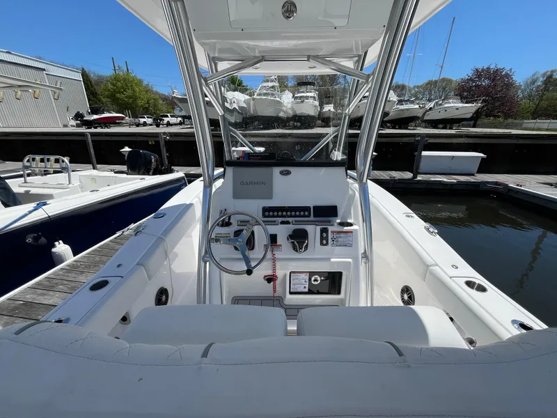 Slide: The Image of 2025 Sea Fox 248 Commander boat interior with steering console at marina. - 3