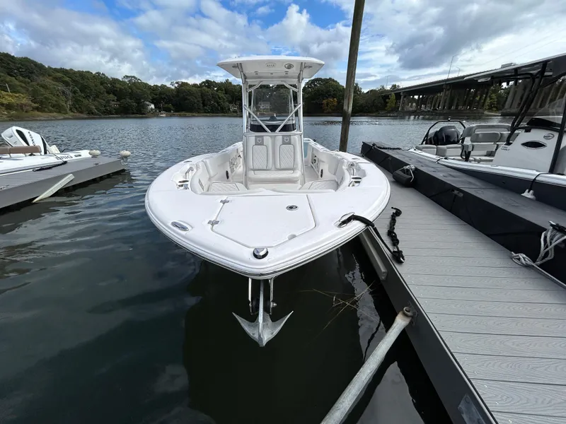 Slide: The Image of 2025 Sea Fox 248 Commander boat docked on a calm river under a cloudy sky. - 5