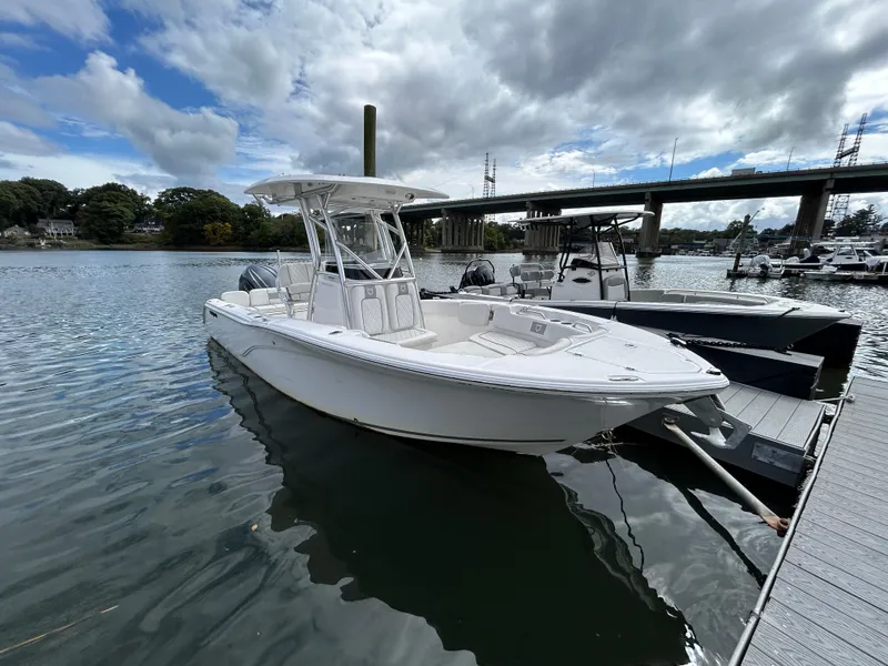 Slide: The Image of 2025 Sea Fox 248 Commander boat docked on a calm river under cloudy skies. - 6