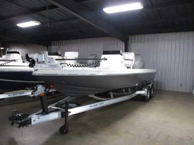 The Image of 2025 Skeeter SX230 boat on trailer in indoor storage facility. - 1