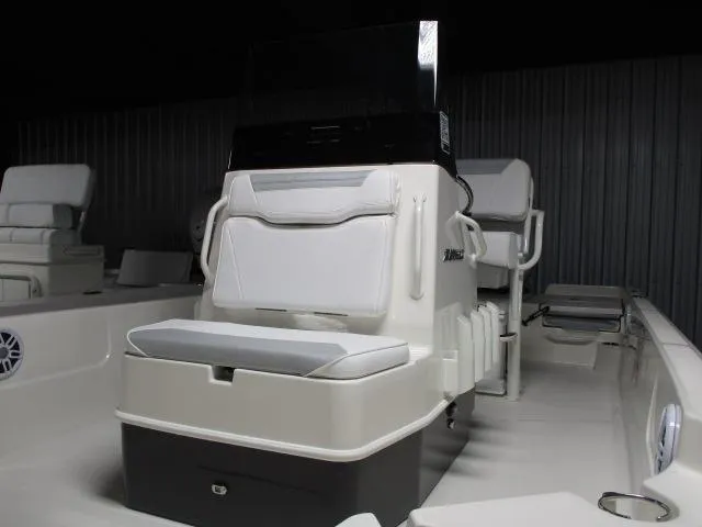 Slide: The Image of 2025 Skeeter SX230 boat interior with cushioned seating and console. - 10