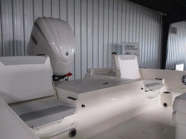 Slide: The Image of 2025 Skeeter SX230 boat interior with Yamaha engine in a storage facility. - 3