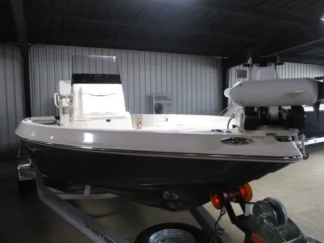 Slide: The Image of 2025 Skeeter SX230 boat in a showroom, displayed on a trailer. - 4