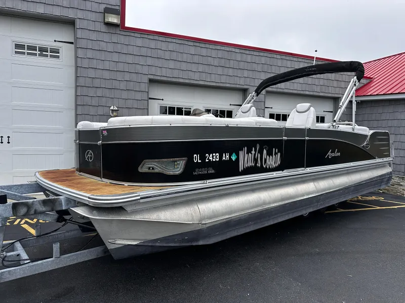 Slide: The Image of 2014 Avalon Catalina Quad Lounge 24' Triple Toon pontoon boat on trailer. - 1